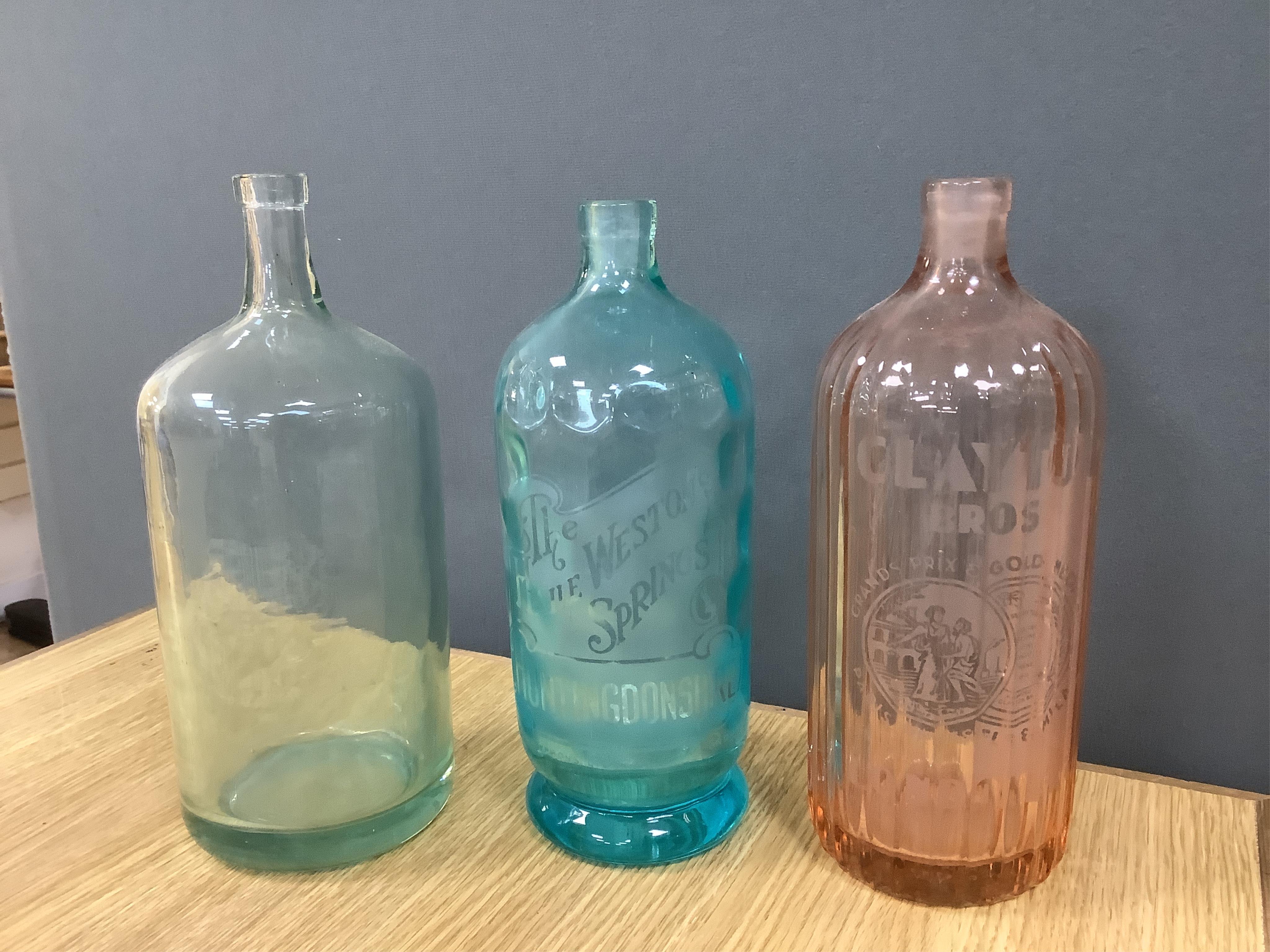 An Edwardian Standard English Seltzogenes double gourd Soda Syphon, one other and a collection of coloured glass bottles. Condition - varies